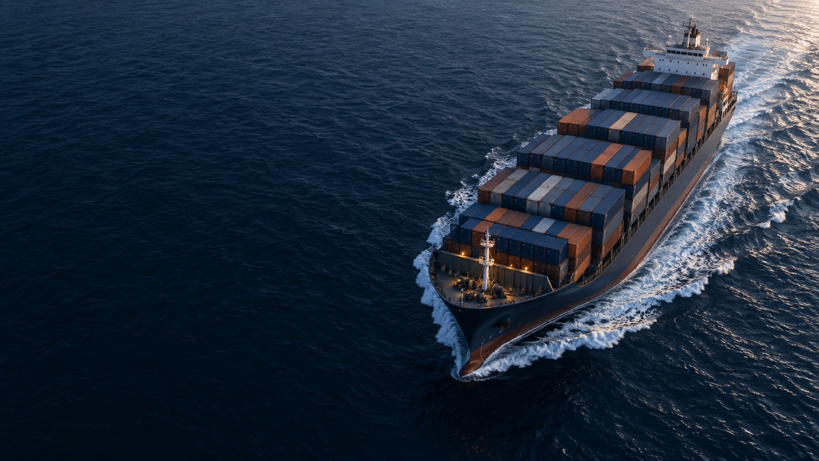 A container ship moving across deep blue ocean